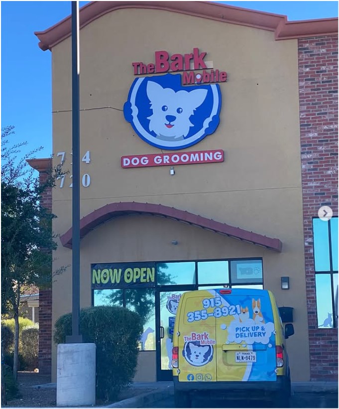 The Bark Mobile Dog Grooming storefront in El Paso with a grooming van parked outside